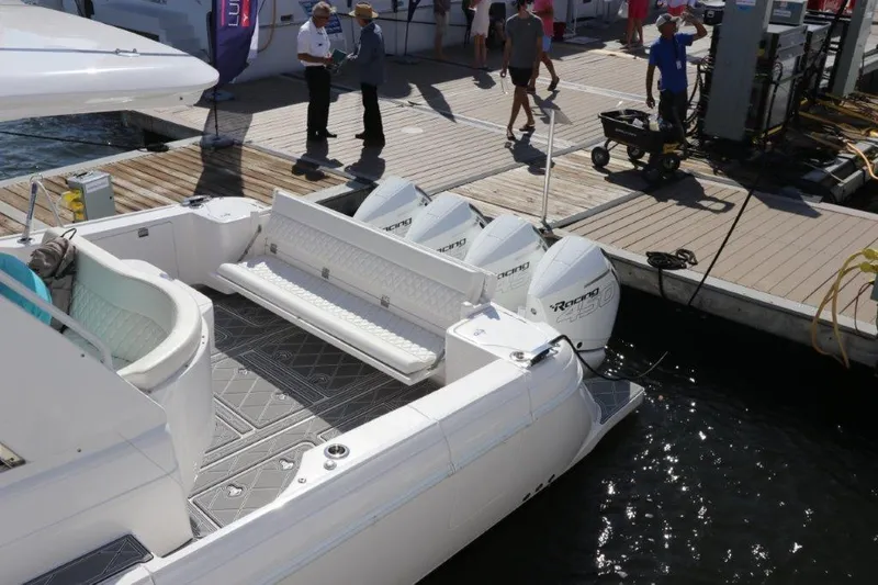 Slide: The Image of 2019 Intrepid 475 Sport Yacht docked, showcasing spacious deck and powerful engines. - 19