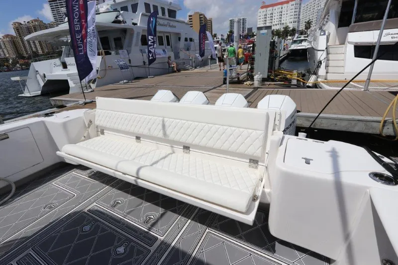 Slide: The Image of 2019 Intrepid 475 Sport Yacht with white seating at a marina dock. - 22