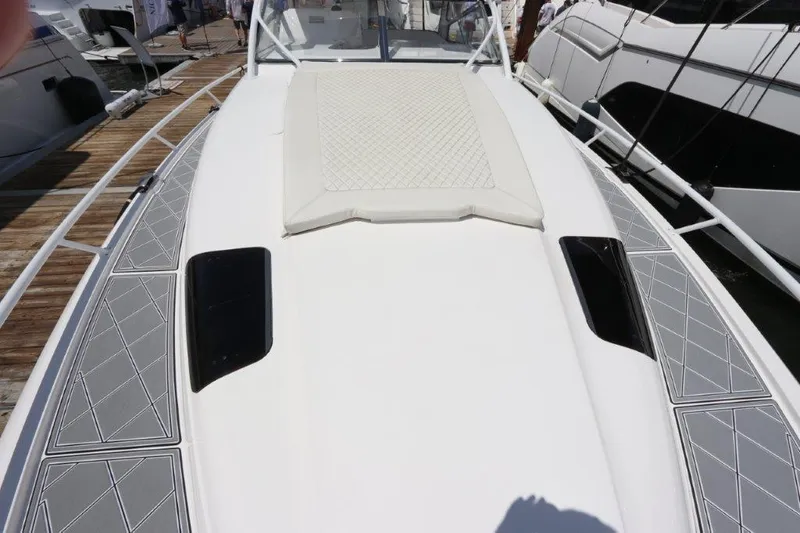 Slide: The Image of 2019 Intrepid 475 Sport Yacht deck with cushioned sunpad and sleek design. - 29