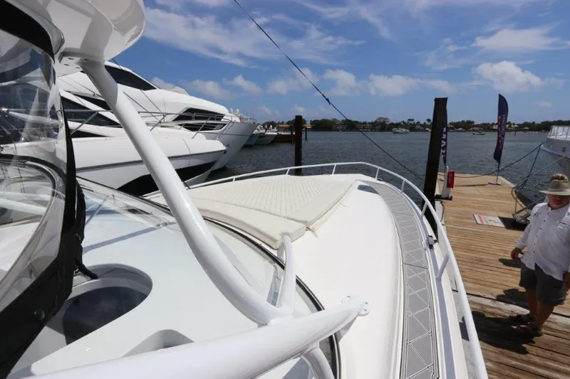 Slide: The Image of 2019 Intrepid 475 Sport Yacht docked at marina under clear blue sky. - 30