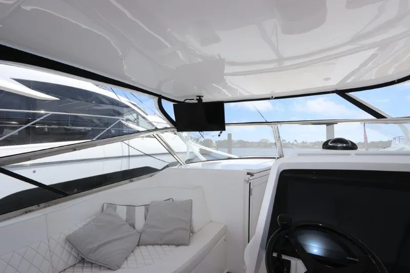 Slide: The Image of Interior view of 2019 Intrepid 475 Sport Yacht with seating and helm. - 31
