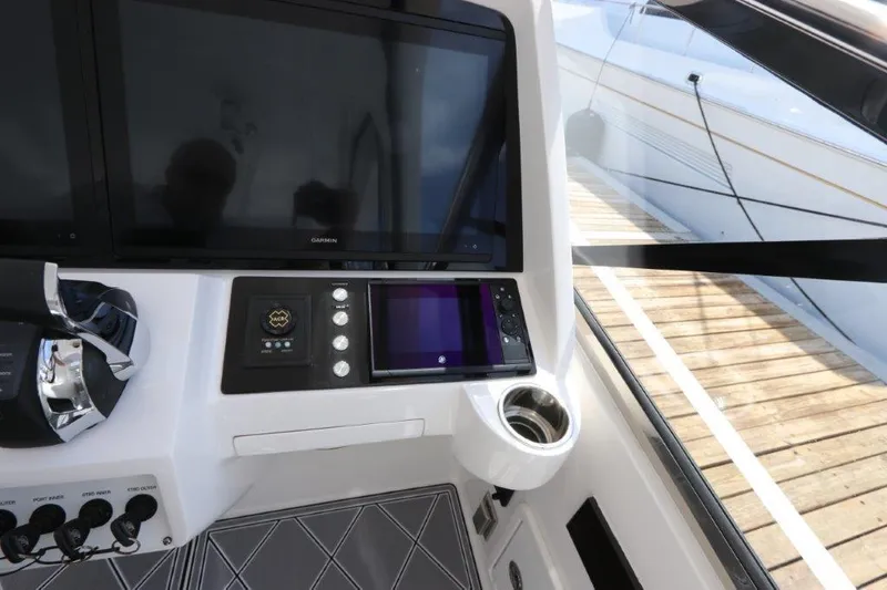 Slide: The Image of 2019 Intrepid 475 Sport Yacht helm with modern navigation displays and controls. - 40