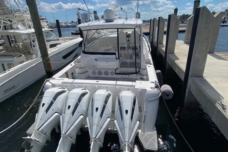 Slide: The Image of 2019 Intrepid 475 Sport Yacht docked with four powerful outboard engines. - 5