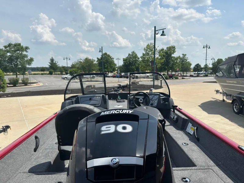 Slide: The Image of 2025 Tracker Pro Guide V-16 WT boat with Mercury 90 engine, parked outdoors. - 4