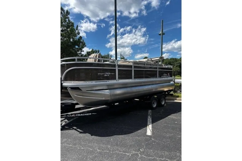 Slide: The Image of 2025 Sun Tracker SportFish 20 DLX pontoon boat on trailer under blue sky. - 2