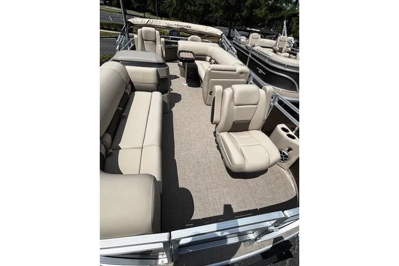 Slide: The Image of 2025 Sun Tracker SportFish 20 DLX pontoon boat with beige seating and spacious interior. - 3