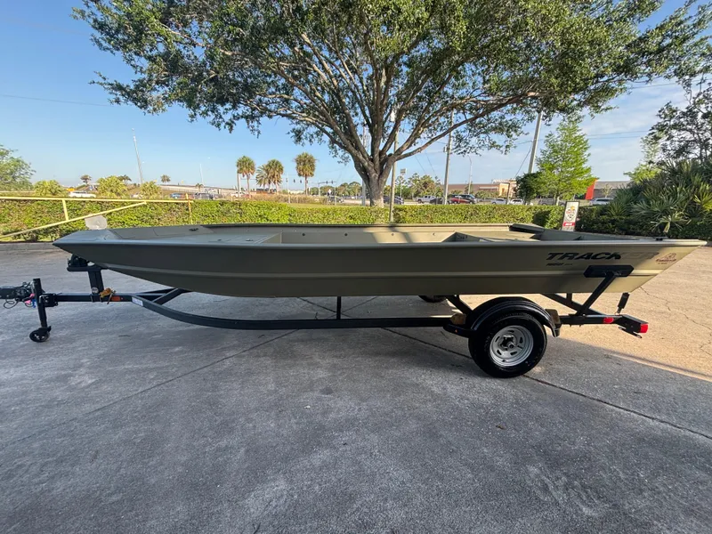 The Image of 2025 Tracker GRIZZLY 1860 Utility boat on trailer, parked outdoors. - 0