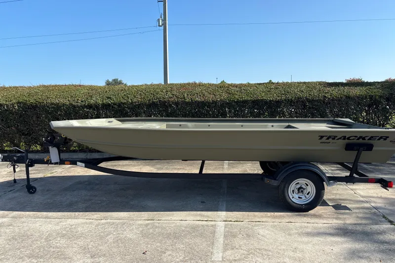 The Image of 2025 Tracker Grizzly 1860 Utility boat on trailer, parked outdoors. - 0