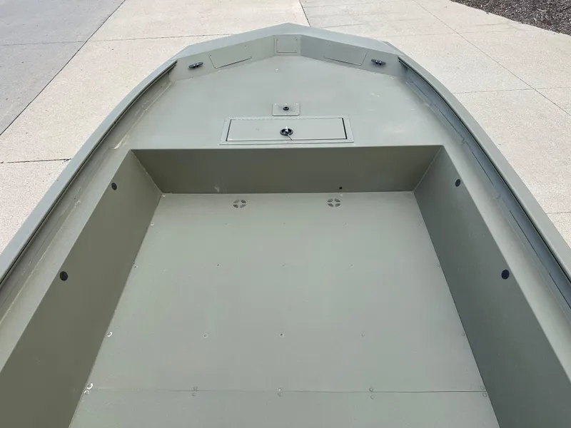 Slide: The Image of 2025 Tracker GRIZZLY 1860 Utility boat interior, showcasing spacious deck and storage compartment. - 3