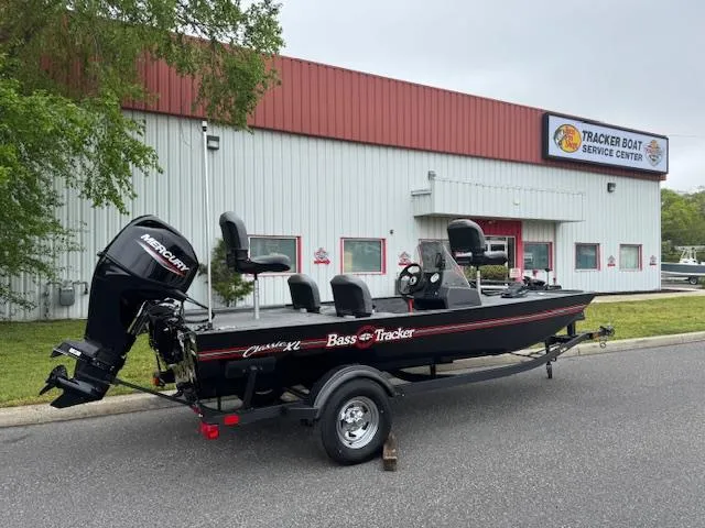 Slide: The Image of 2025 Tracker Bass Tracker Classic XL boat outside service center. - 2