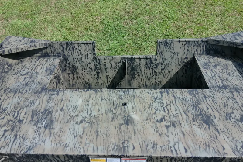 Slide: The Image of 2025 Tracker Grizzly 1860 Utility boat with camouflage pattern on grassy background. - 30