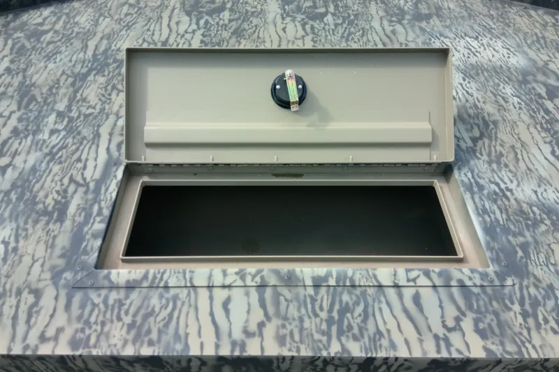 Slide: The Image of Open storage compartment on 2025 Tracker Grizzly 1860 Utility boat with camouflage pattern. - 31