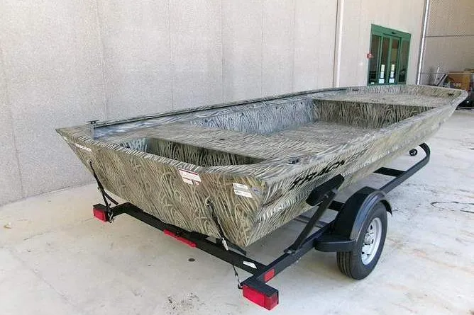 Slide: The Image of 2025 Tracker Grizzly 1860 Utility boat on trailer, featuring a camouflage design. - 2