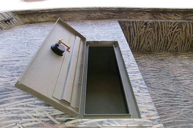 Slide: The Image of Open storage compartment on 2025 Tracker Grizzly 1860 Utility boat deck. - 6
