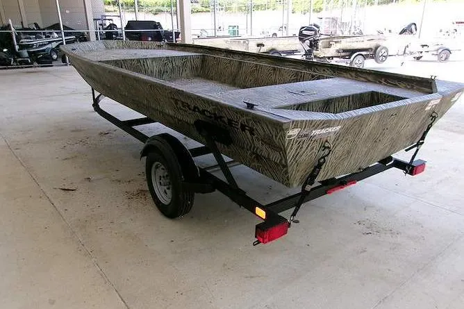 Slide: The Image of 2025 Tracker Grizzly 1860 Utility boat on trailer in a covered area. - 3