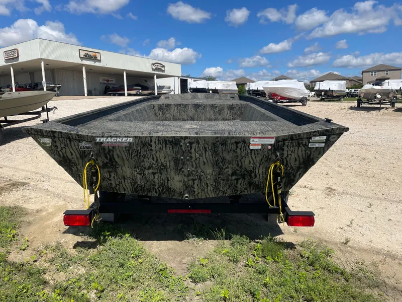 Slide: The Image of 2025 Tracker GRIZZLY 1860 Utility boat on trailer, parked outdoors under blue sky. - 5