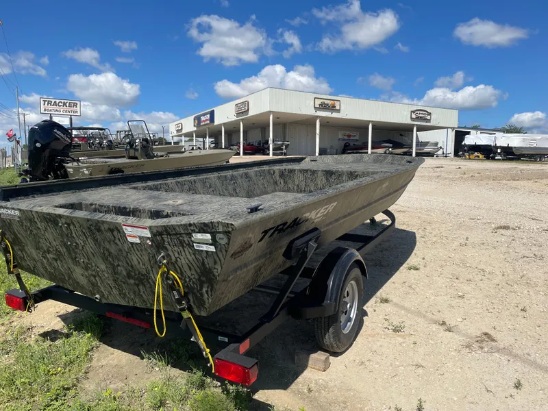 Slide: The Image of 2025 Tracker GRIZZLY 1860 Utility boat on trailer, dealership background, sunny day. - 6