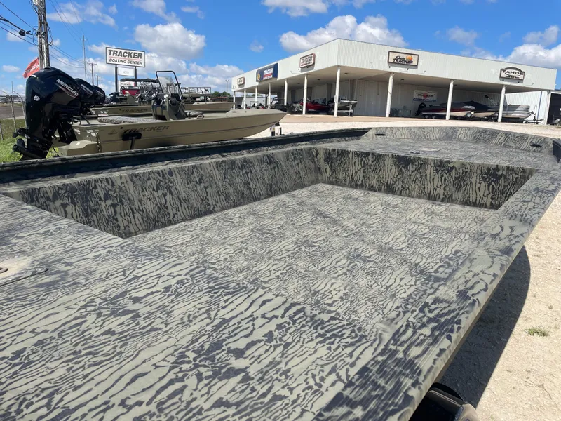 Slide: The Image of 2025 Tracker GRIZZLY 1860 Utility boat at dealership under blue sky. - 8