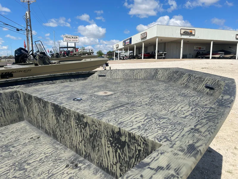Slide: The Image of 2025 Tracker GRIZZLY 1860 Utility boat at dealership under blue sky. - 9