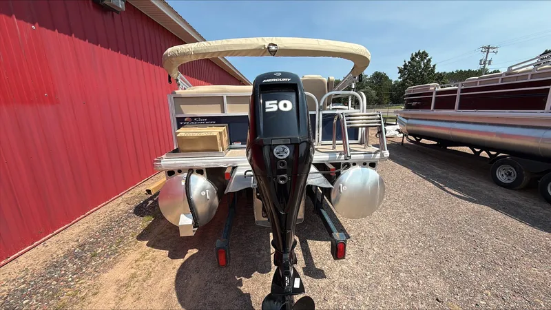Slide: The Image of 2025 Sun Tracker Bass Buggy 16 XL Select with Mercury 50 outboard motor, parked outdoors. - 3