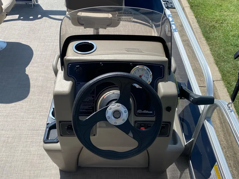 Slide: The Image of 2025 Sun Tracker Bass Buggy 16 XL Select steering console with cup holder and gauge. - 6