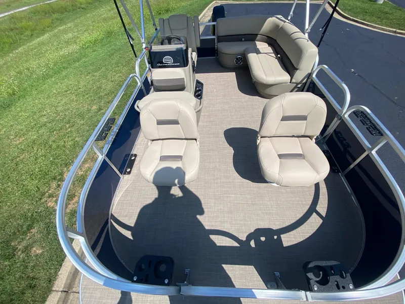 Slide: The Image of 2025 Sun Tracker Bass Buggy 16 XL Select pontoon boat interior with seating and railing. - 8