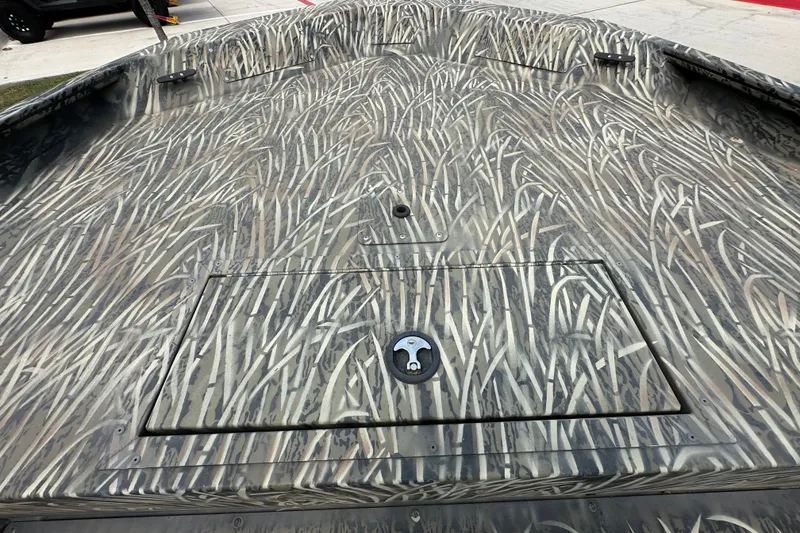 Slide: The Image of 2025 Tracker Grizzly 1860 Utility boat with camouflage pattern on deck. - 22