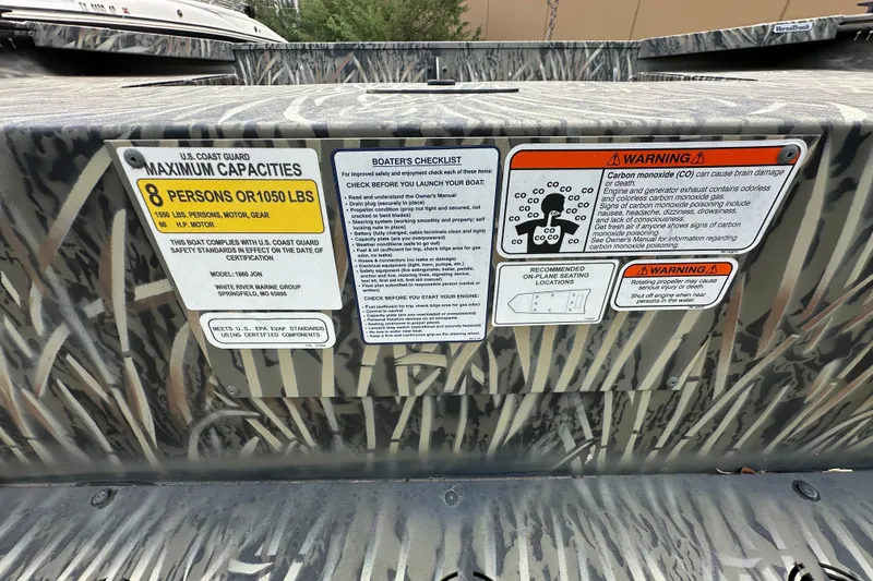 Slide: The Image of 2025 Tracker Grizzly 1860 Utility boat capacity and safety warning labels. - 25