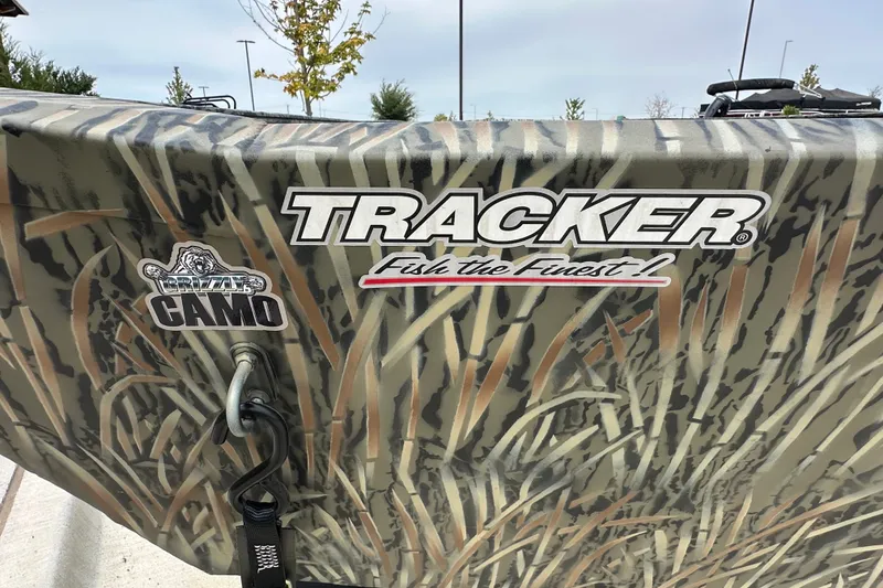 Slide: The Image of 2025 Tracker Grizzly 1860 Utility boat with camo design and logo. - 14
