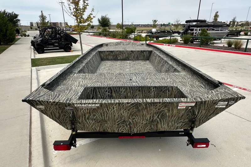 Slide: The Image of 2025 Tracker Grizzly 1860 Utility boat with camouflage design on a trailer. - 13