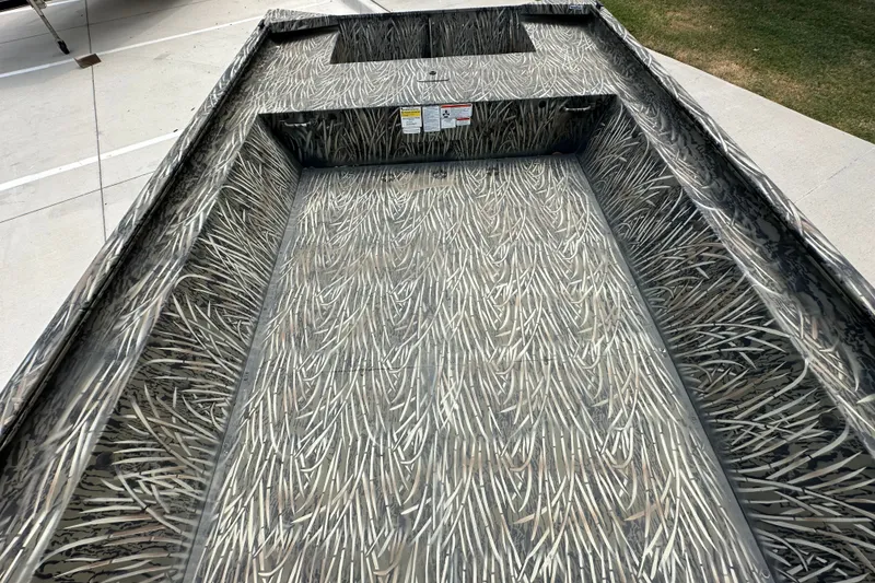 Slide: The Image of 2025 Tracker Grizzly 1860 Utility boat with camouflage interior design on display. - 23