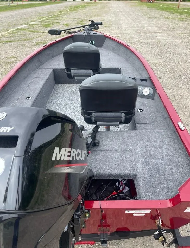 Slide: The Image of 2025 Tracker Super Guide V-16 T boat with Mercury engine, featuring dual seats and spacious interior. - 4