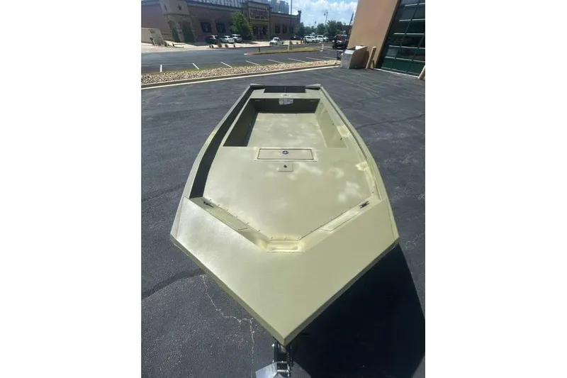 Slide: The Image of 2025 Tracker Grizzly 1860 Utility boat on pavement, showcasing spacious deck design. - 4