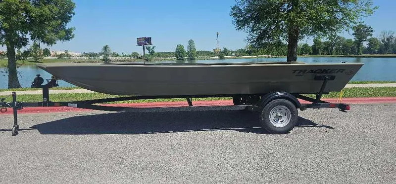 The Image of 2025 Tracker Grizzly 1860 Utility boat on trailer, parked on roadside. - 0
