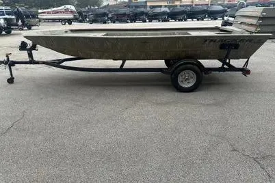 The Image of 2025 Tracker Grizzly 1754 Jon boat on trailer in parking lot. - 0