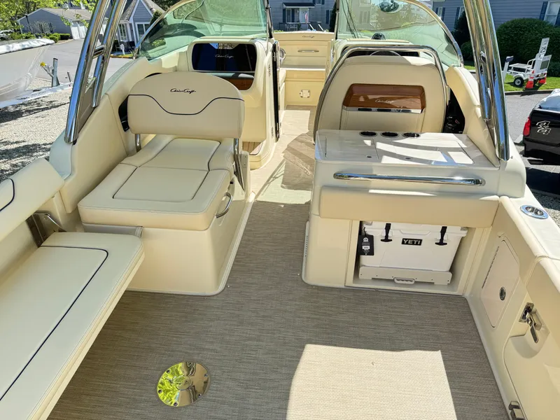 Slide: The Image of 2025 Chris-Craft Calypso 28 boat interior with beige seating and modern amenities. - 10