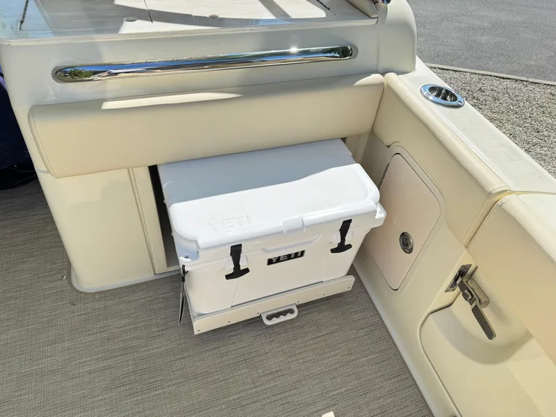 Slide: The Image of 2025 Chris-Craft Calypso 28 boat interior with built-in cooler storage. - 11