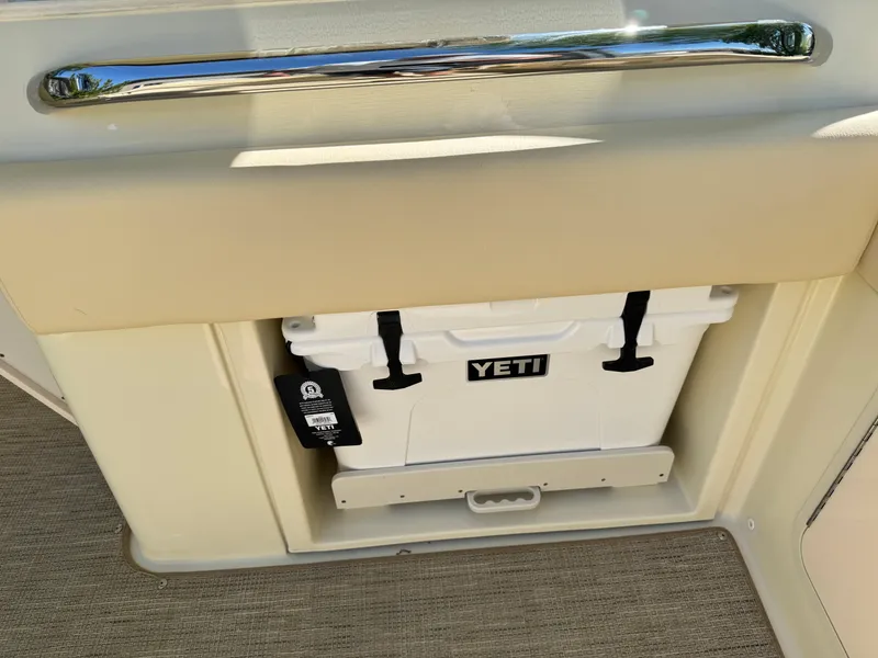 Slide: The Image of 2025 Chris-Craft Calypso 28 with Yeti cooler storage compartment. - 12