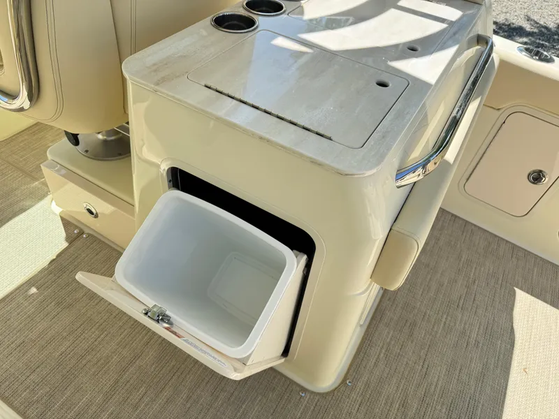 Slide: The Image of 2025 Chris-Craft Calypso 28 boat interior with open storage compartment and cup holders. - 13