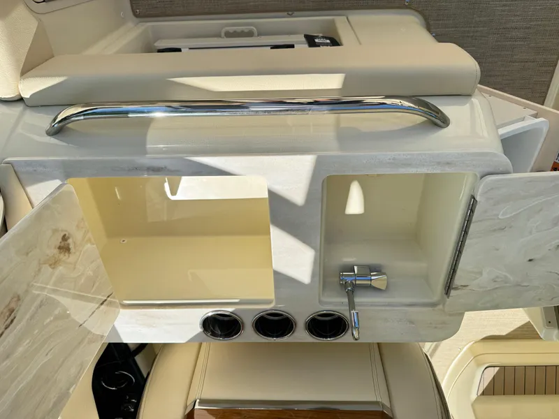 Slide: The Image of 2025 Chris-Craft Calypso 28 boat interior with open storage and faucet. - 14