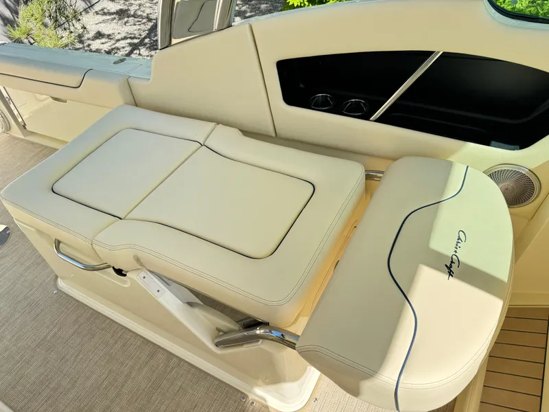 Slide: The Image of 2025 Chris-Craft Calypso 28 boat interior with cream leather seating and elegant design. - 16