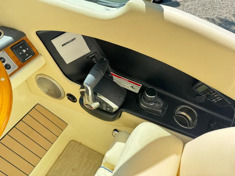 Slide: The Image of Control panel of 2025 Chris-Craft Calypso 28 boat with Mercury throttle and speaker. - 22