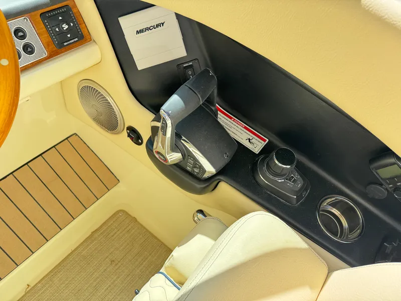 Slide: The Image of Control panel of 2025 Chris-Craft Calypso 28 boat with Mercury throttle and speaker. - 23