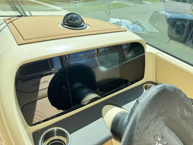 Slide: The Image of 2025 Chris-Craft Calypso 28 dashboard with modern navigation system and compass. - 24