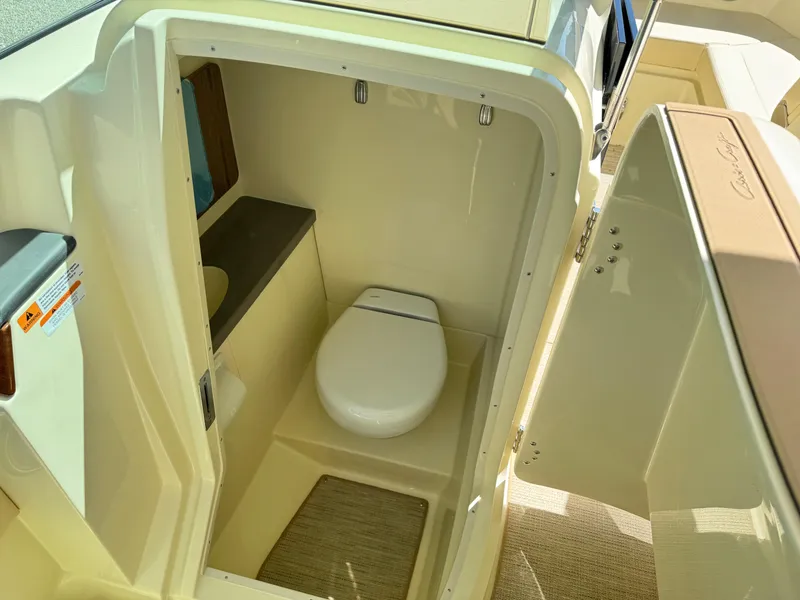 Slide: The Image of 2025 Chris-Craft Calypso 28 boat interior with compact bathroom and toilet. - 26