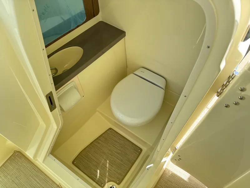 Slide: The Image of 2025 Chris-Craft Calypso 28 boat bathroom with toilet and sink. - 27