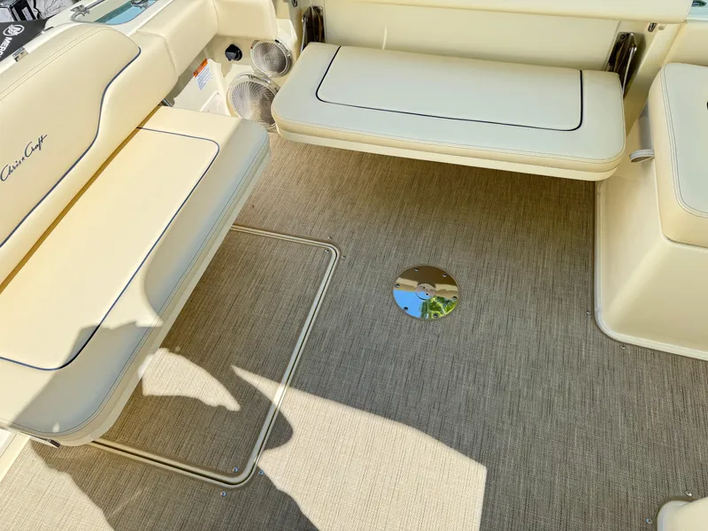 Slide: The Image of 2025 Chris-Craft Calypso 28 interior with beige seating and carpeted flooring. - 7
