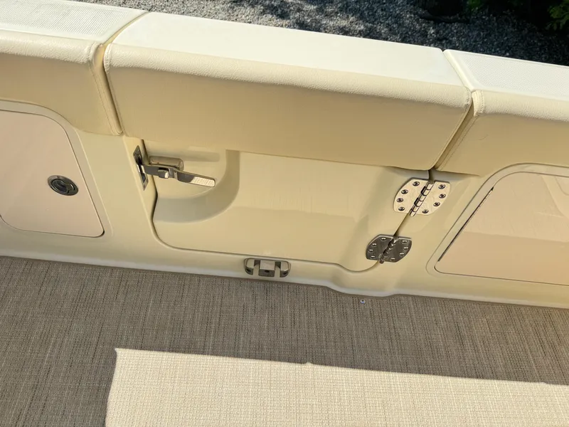 Slide: The Image of 2025 Chris-Craft Calypso 28 boat interior detail with beige upholstery and hardware. - 9