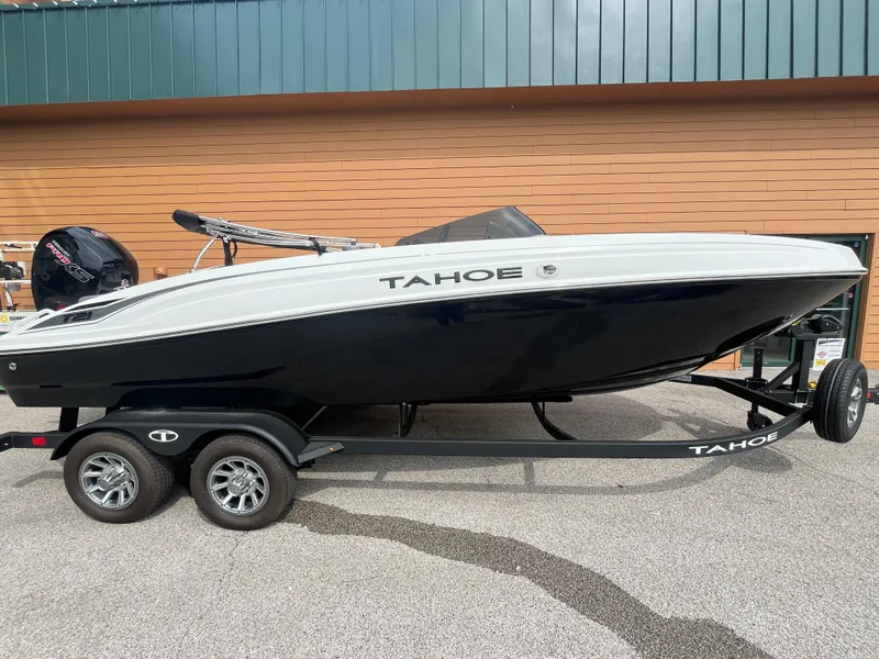 The Image of 2025 Tahoe T21 boat on trailer, parked outdoors. - 0