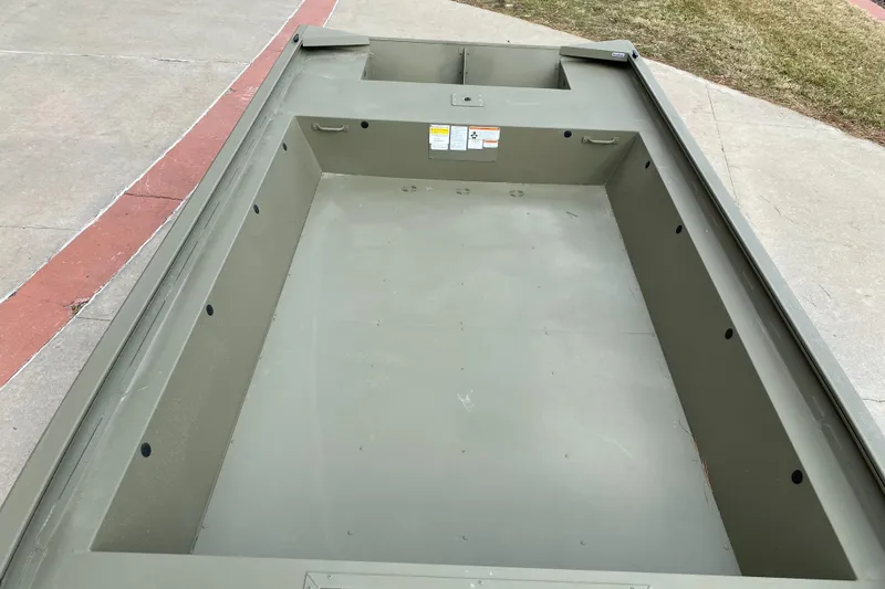 Slide: The Image of 2025 Tracker GRIZZLY 1860 Utility boat, empty interior view on concrete surface. - 4